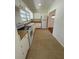 Bright kitchen featuring white cabinets, appliances, and light countertops at 708 Keeling St, Brooksville, FL 34601