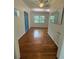 Bright living room featuring hardwood floors and a view of the trees outdoors at 708 Keeling St, Brooksville, FL 34601