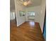 View of living room with hardwood floors, and a glimpse of the kitchen at 708 Keeling St, Brooksville, FL 34601