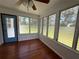 Sunroom featuring hardwood floors, white beadboard paneling, and jalousie windows at 708 Keeling St, Brooksville, FL 34601