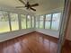 Bright sunroom with lots of natural light, hardwood floors, and a ceiling fan at 708 Keeling St, Brooksville, FL 34601
