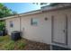 Back exterior with A/C unit and entrance door at 725 2Nd Ne Ave, Largo, FL 33770