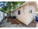 View of back exterior of house with a tree and A/C unit at 725 2Nd Ne Ave, Largo, FL 33770