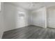 A bright bedroom featuring gray wood-look flooring, a ceiling fan, and a window at 725 2Nd Ne Ave, Largo, FL 33770