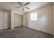 Neutral bedroom featuring carpeted floors, ceiling fan, window, and walk in closet at 725 2Nd Ne Ave, Largo, FL 33770