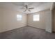 Neutral bedroom featuring carpeted floors, ceiling fan, two windows, and closet at 725 2Nd Ne Ave, Largo, FL 33770