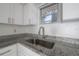 Close-up of the kitchen sink, showing the granite countertop and faucet at 725 2Nd Ne Ave, Largo, FL 33770