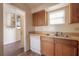 A kitchen featuring wood cabinets, laminate countertops, and standard appliances at 725 2Nd Ne Ave, Largo, FL 33770