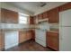 An efficient kitchen featuring wooden cabinetry and standard appliances at 725 2Nd Ne Ave, Largo, FL 33770