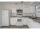 Well-equipped kitchen with stainless appliances and granite counters is ready for cooking at 725 2Nd Ne Ave, Largo, FL 33770