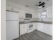 Modern kitchen featuring white cabinets, granite countertops, and stainless steel appliances at 725 2Nd Ne Ave, Largo, FL 33770