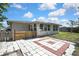 Backyard features partial fencing and enclosed porch attached to the home at 7810 Pineapple Ln, Port Richey, FL 34668