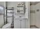 Compact bathroom featuring a tiled shower, toilet, and vanity with storage at 7810 Pineapple Ln, Port Richey, FL 34668