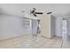 Bedroom with tile flooring, featuring a ceiling fan and an ensuite bathroom at 7810 Pineapple Ln, Port Richey, FL 34668