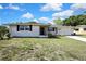 Charming single Gathering home with a brick facade, driveway, and front yard landscaping at 7810 Pineapple Ln, Port Richey, FL 34668