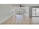 Spacious living room featuring tile floors, ceiling fan, and natural light at 7810 Pineapple Ln, Port Richey, FL 34668