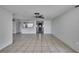 Open-concept living area with tile flooring flows into the kitchen, perfect for entertaining at 7810 Pineapple Ln, Port Richey, FL 34668