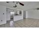 View of the living area showcasing tile flooring and an open layout to the kitchen at 7810 Pineapple Ln, Port Richey, FL 34668