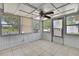 Enclosed sun room featuring white walls and floors with many windows at 7810 Pineapple Ln, Port Richey, FL 34668