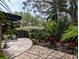 Landscaped backyard with lush greenery, a patio, and a wooden fence at 8260 32Nd N Ave, St Petersburg, FL 33710