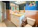 A bathroom features granite vanity and toilet with blue walls and pink tile at 8260 32Nd N Ave, St Petersburg, FL 33710