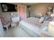 Bright bedroom featuring striped bedding, a small desk, and an accent chair with a TV at 8260 32Nd N Ave, St Petersburg, FL 33710