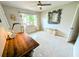 Bedroom with a window view, ceiling fan, mosaic floors, a decorative mirror and a writing desk at 8260 32Nd N Ave, St Petersburg, FL 33710