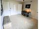 Bedroom features 2 white doors, a desk, and a mosaic floor design at 8260 32Nd N Ave, St Petersburg, FL 33710