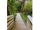 A picturesque elevated wooden boardwalk passes through a natural green area at 8260 32Nd N Ave, St Petersburg, FL 33710