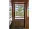 Charming wooden door providing seamless access to the lush outdoor patio and garden area at 8260 32Nd N Ave, St Petersburg, FL 33710