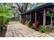 Scenic view of the home's exterior with a screened porch and a vibrant brick pathway at 8260 32Nd N Ave, St Petersburg, FL 33710