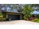 Charming home featuring a modern garage door and lush tropical landscaping adding to its curb appeal at 8260 32Nd N Ave, St Petersburg, FL 33710
