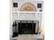 Close-up of a brick fireplace with a decorative mantel and accessories at 8260 32Nd N Ave, St Petersburg, FL 33710