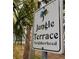 A welcoming neighborhood sign surrounded by a palm tree, with beautiful beach views in the distance at 8260 32Nd N Ave, St Petersburg, FL 33710