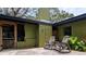 Inviting patio space with rocking chairs, a wood pile, and unique vintage decorations at 8260 32Nd N Ave, St Petersburg, FL 33710