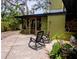 Charming patio with rocking chairs, a wood pile, and a view of the screened-in porch at 8260 32Nd N Ave, St Petersburg, FL 33710