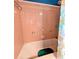 A shower with peach tiling and a decorative sea shell pattern at 8260 32Nd N Ave, St Petersburg, FL 33710