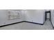 Cozy bedroom offering gray walls, dark trim, modern floors, and natural light through the window at 8603 N 9Th St, Tampa, FL 33604