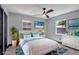 Charming bedroom features hardwood floors, fan, and natural light from two large windows at 8603 N 9Th St, Tampa, FL 33604