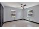 Bright bedroom featuring neutral paint, fan, and natural light from two large windows at 8603 N 9Th St, Tampa, FL 33604