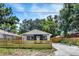 Cozy single-story house featuring a fenced yard, fresh exterior paint, and a private driveway at 8603 N 9Th St, Tampa, FL 33604