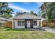 Charming single-story home with a well-manicured lawn, complemented by a newly painted exterior at 8603 N 9Th St, Tampa, FL 33604