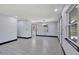 Spacious living area featuring sleek flooring, neutral walls, and recessed lighting, creating a modern aesthetic at 8603 N 9Th St, Tampa, FL 33604