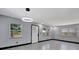 Open living space featuring modern lighting, neutral walls, sleek floors, and multiple windows for ample sunlight at 8603 N 9Th St, Tampa, FL 33604