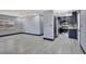 Open-concept living room and kitchen featuring gray walls and wood-look tile flooring at 8603 N 9Th St, Tampa, FL 33604