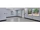 Bright living area with light gray walls, dark trim, modern floors, and natural light through the windows at 8603 N 9Th St, Tampa, FL 33604