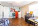 Basement featuring a bed, storage cabinets, a refrigerator, and a work area at 9020 Gray Fox Ln, Port Richey, FL 34668
