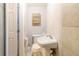 Small bathroom with a toilet, sink, and mirror, complemented by tiled walls at 9020 Gray Fox Ln, Port Richey, FL 34668