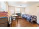 Bedroom with wood floors, twin bed, desk, and lots of personal items at 9020 Gray Fox Ln, Port Richey, FL 34668