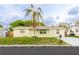 Charming single-story home featuring a well-kept lawn, a mature palm tree, and a private driveway at 9020 Gray Fox Ln, Port Richey, FL 34668